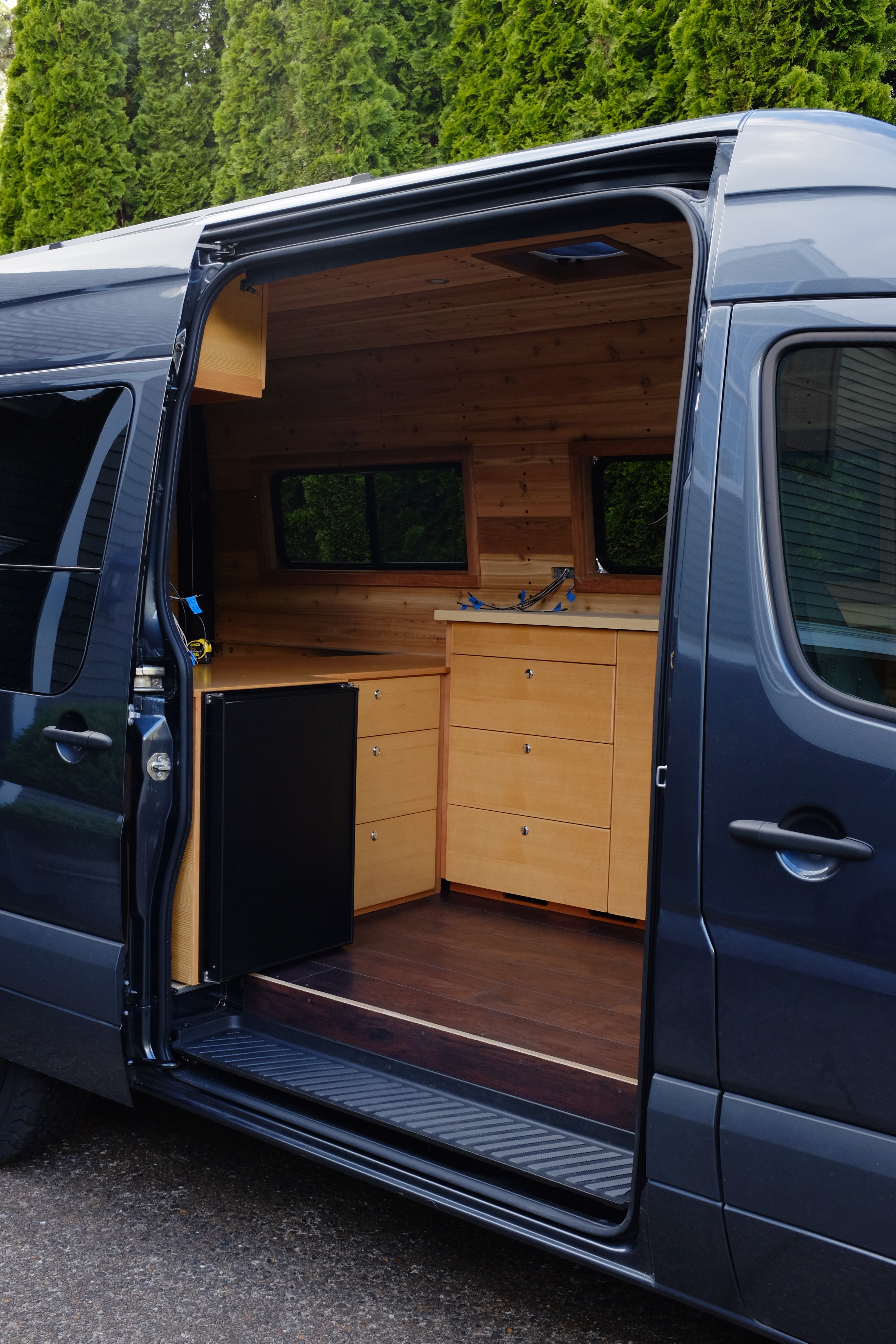 custom cabinets installed to sprinter camper conversion - van build kitchen design