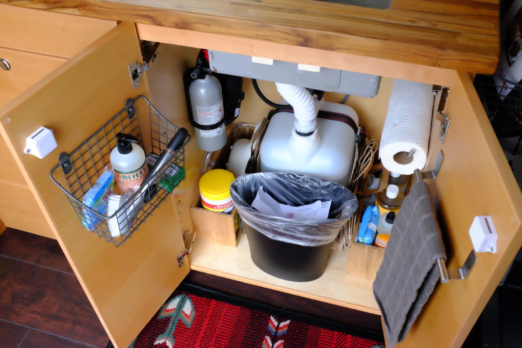 utility shelves and grey water tank under sink in so we bought a van