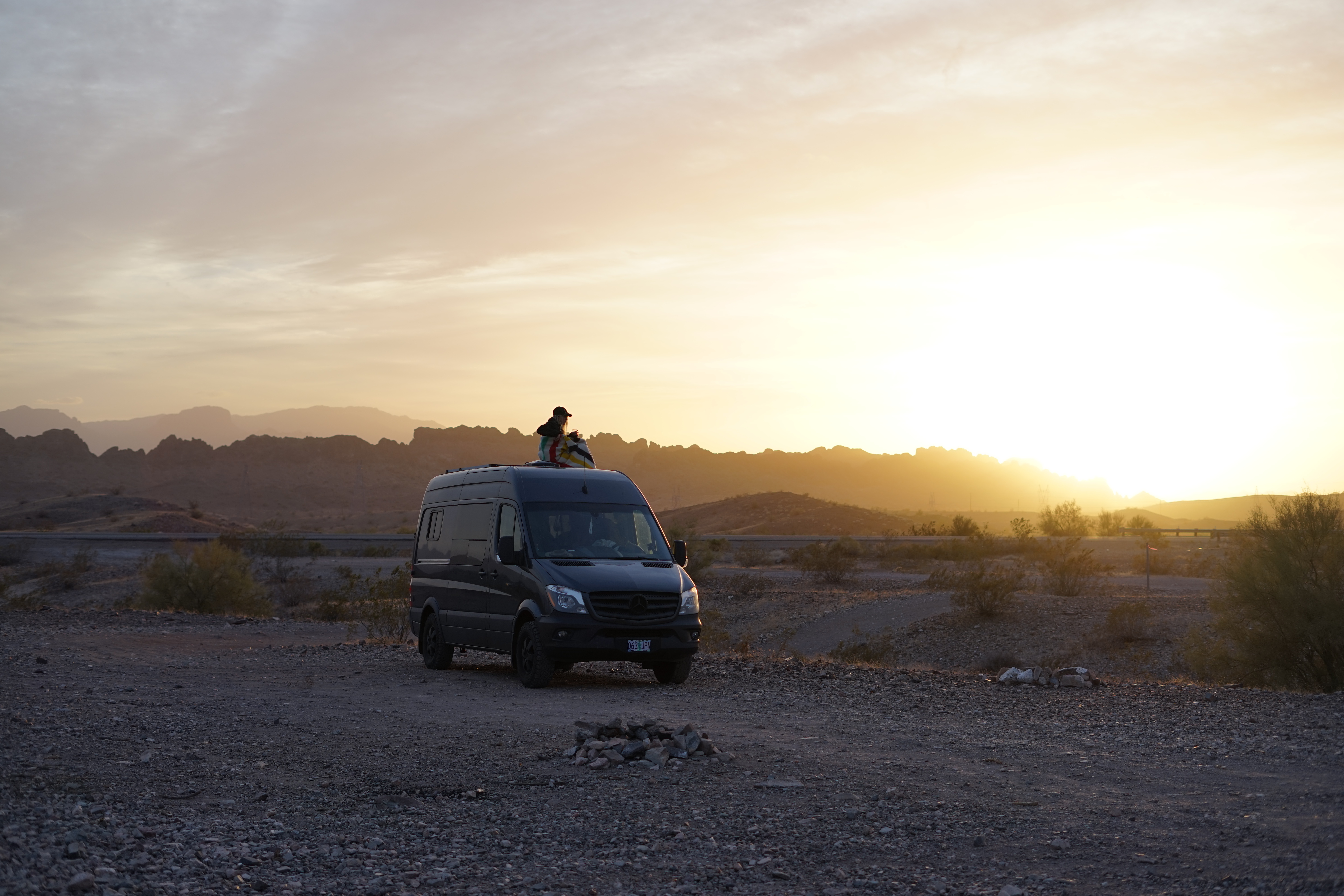 drinking wine at sunset on the top of our sprinter outside of lake havasu in arizona