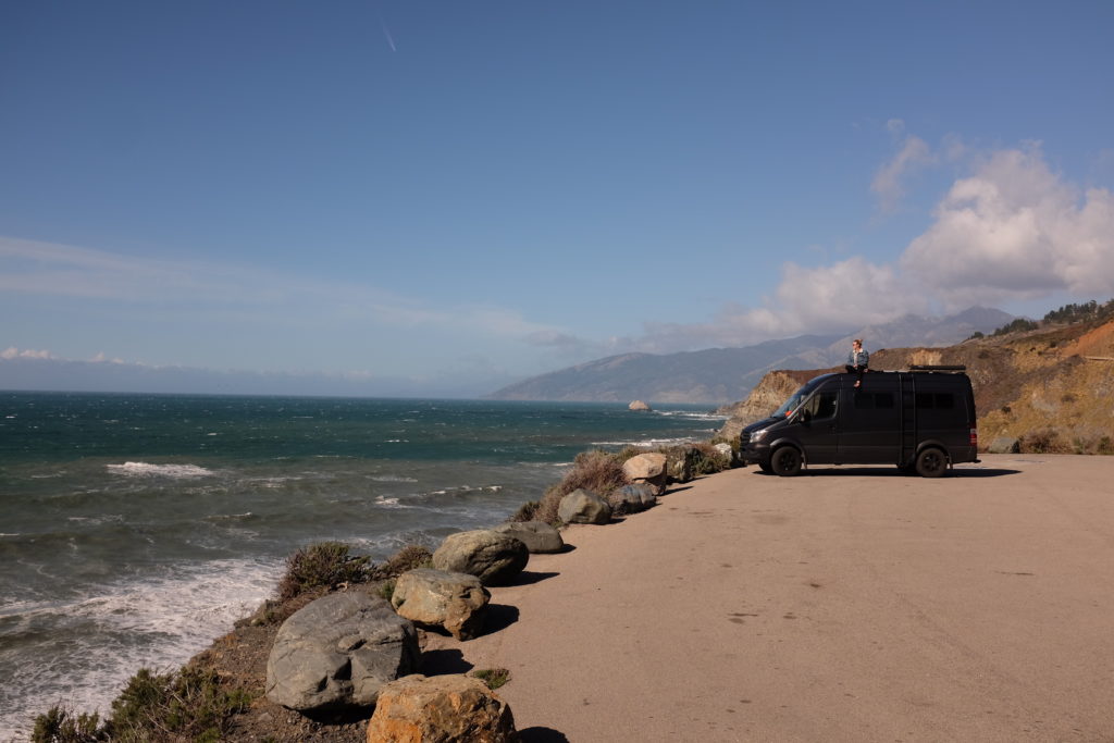 van parked by ocean - visit by van